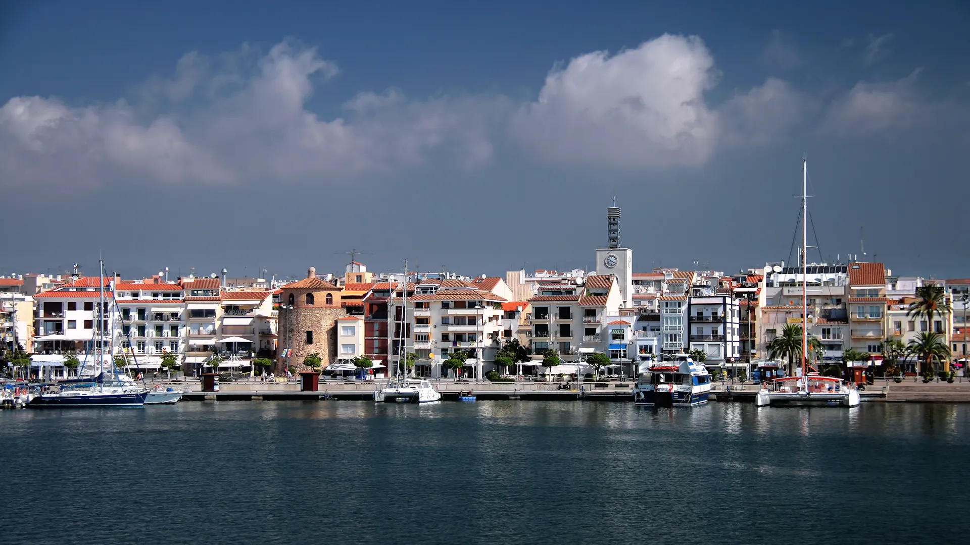Cambrils harbour with boats and the town behind it
